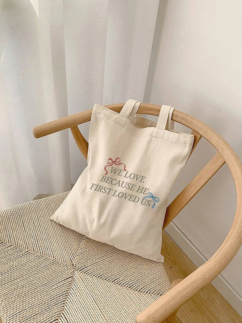 HE FIRST LOVED US Tote Bag