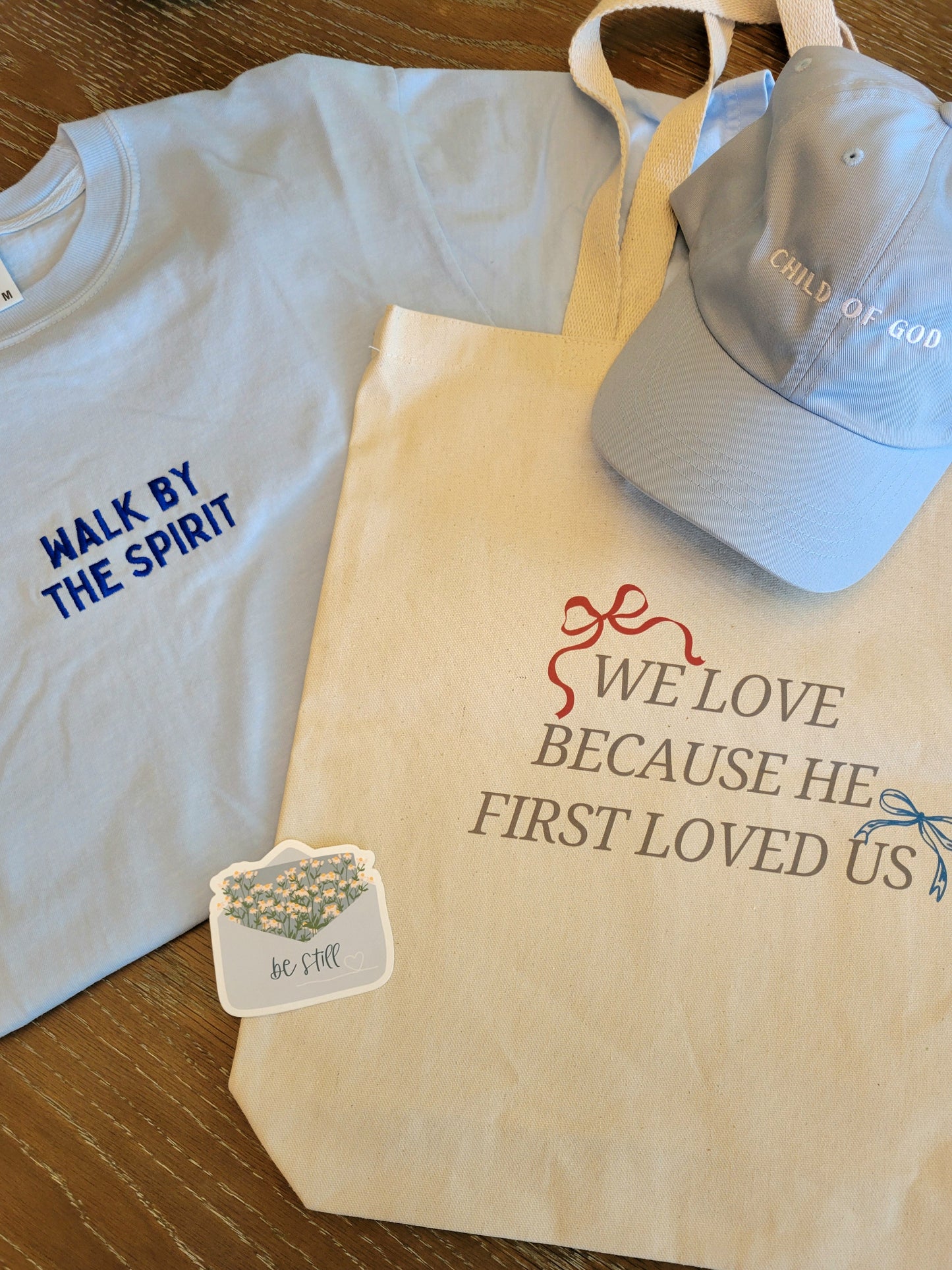 HE FIRST LOVED US Tote Bag